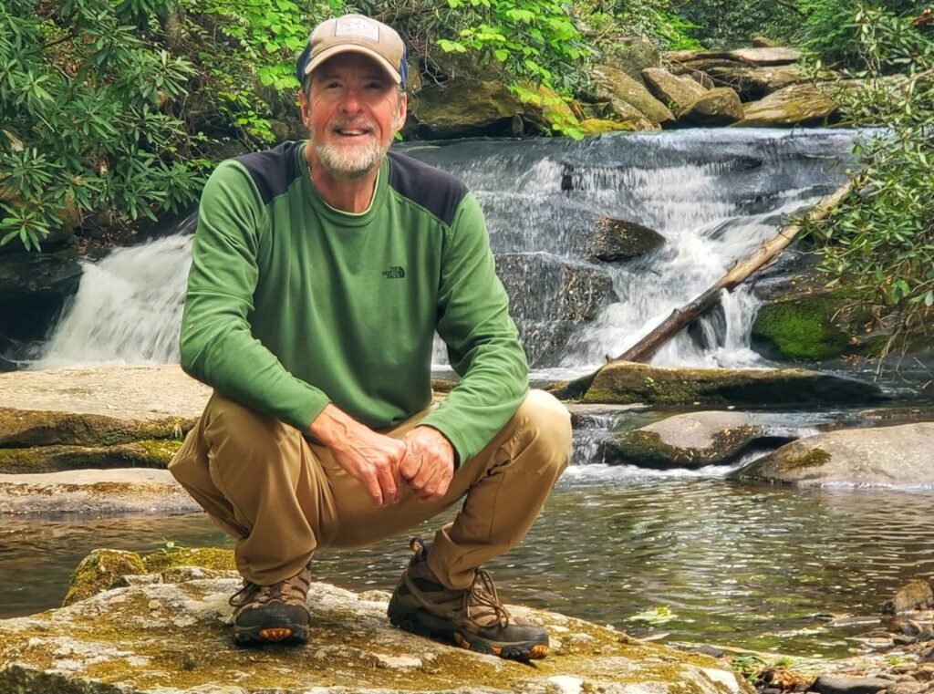 PN to Purpose founder John Kilgore seated beside a waterfall